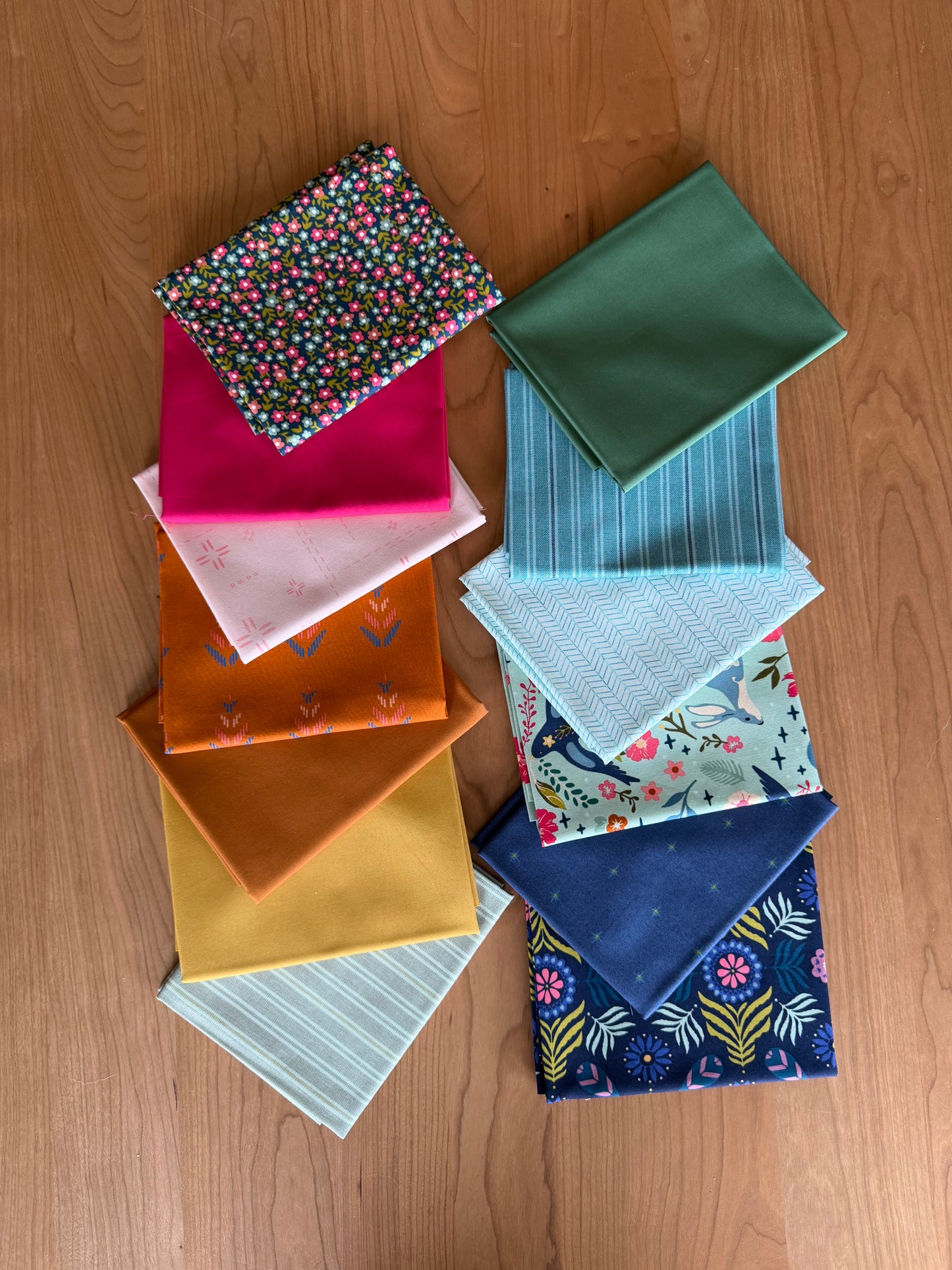 Collection of colorful fabric samples on a wooden surface