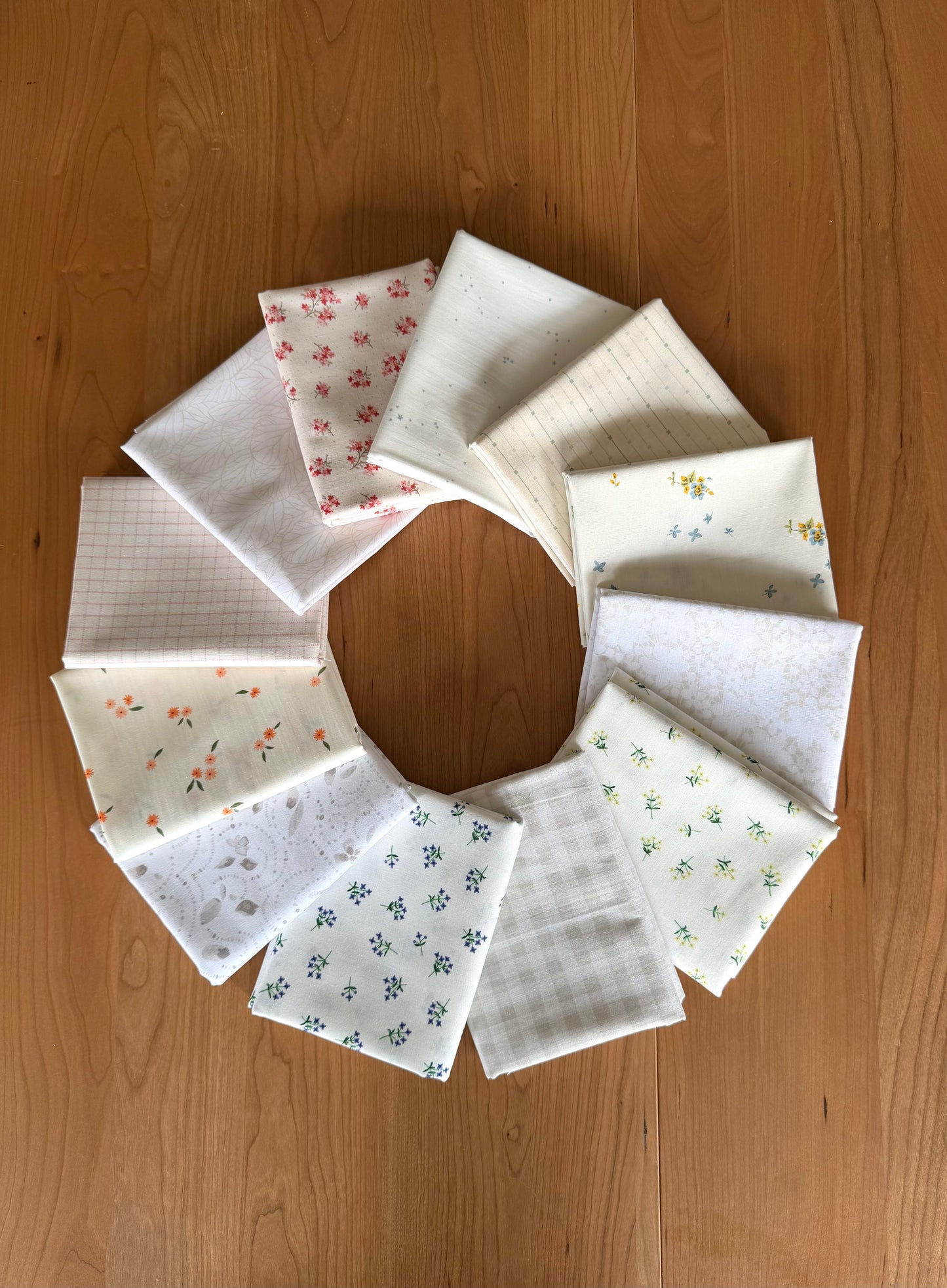 Circular arrangement of fabric samples on a wooden surface