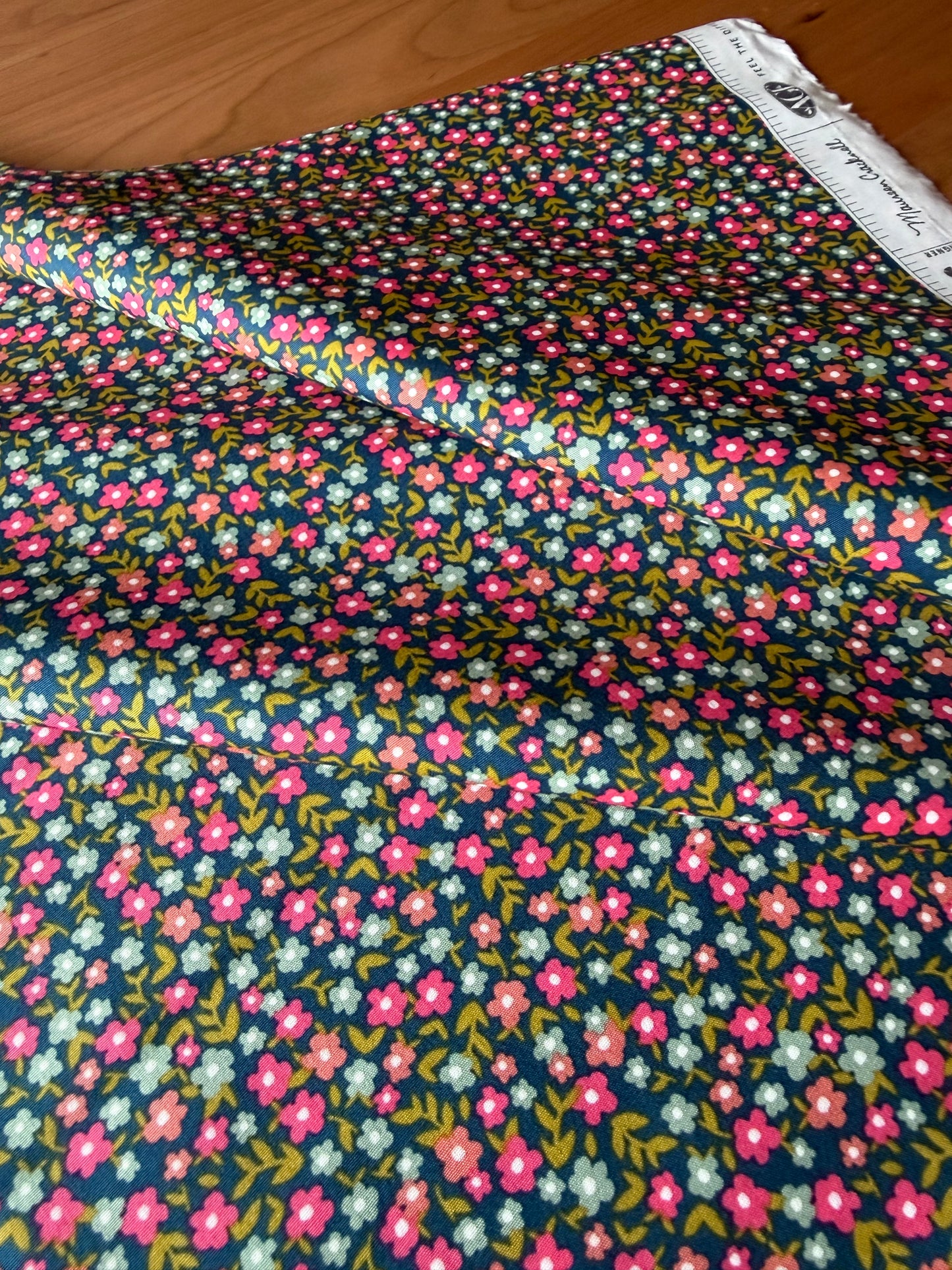 Floral fabric with pink and blue flowers on a navy background