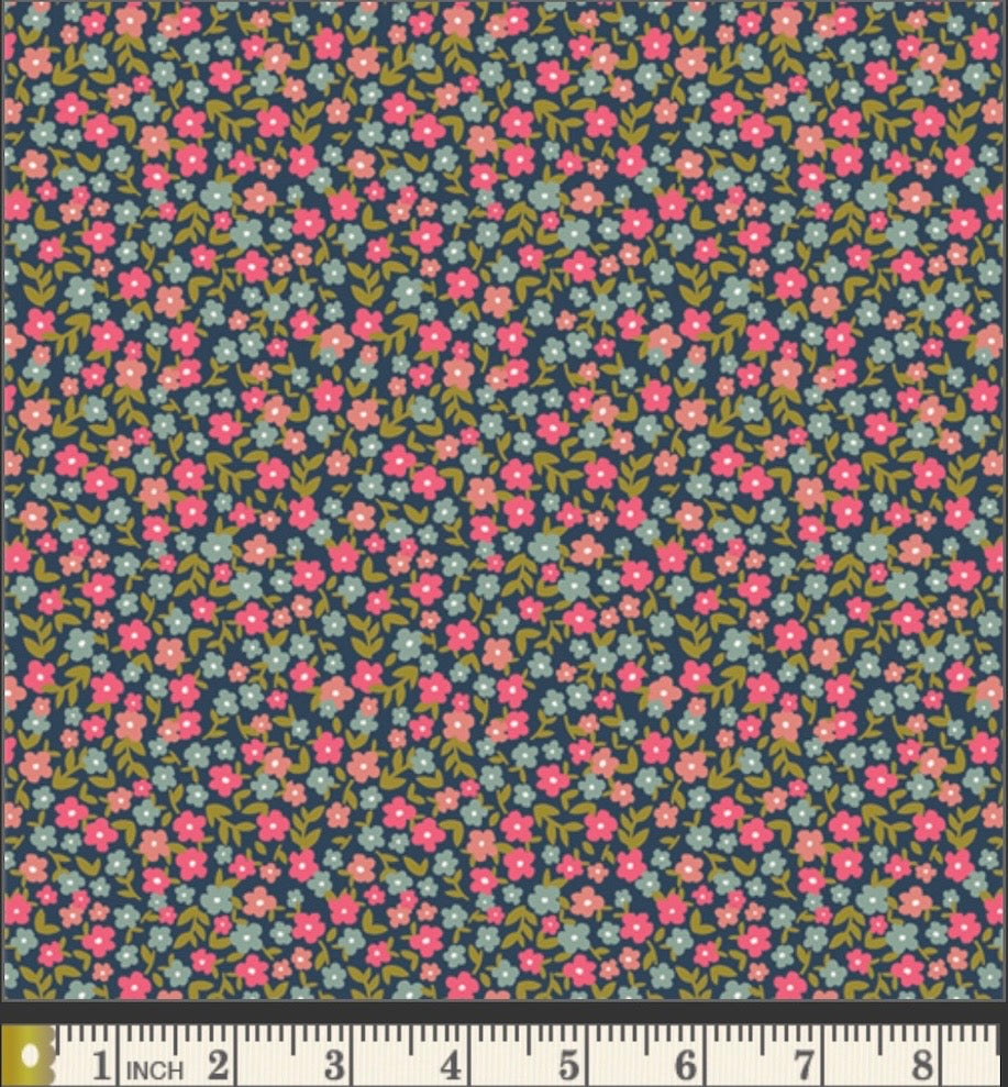 Floral patterned fabric with a ruler for scale on a blue background